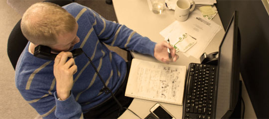 Team member taking notes during a call